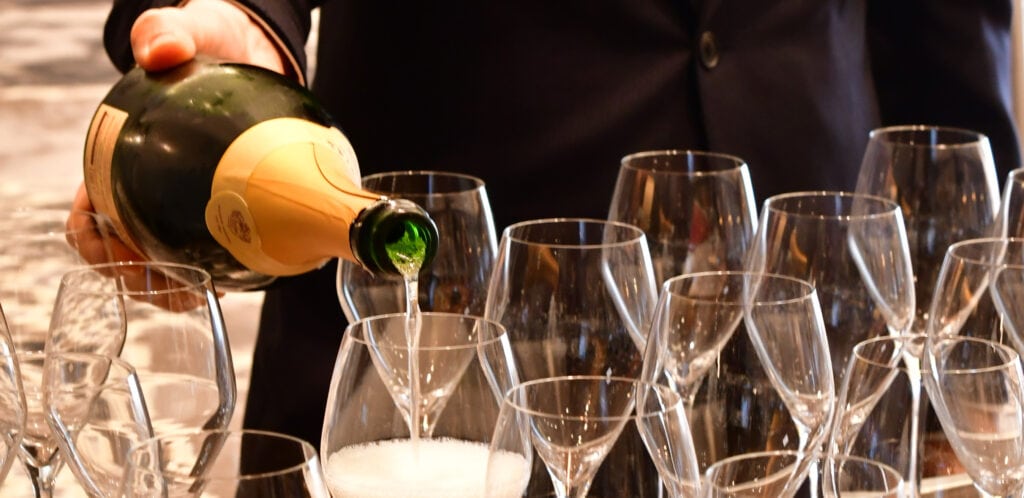 filling up wine glasses