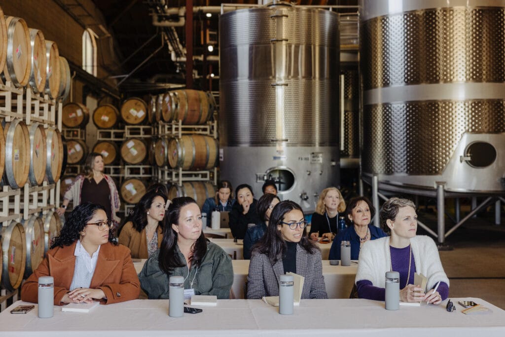 Women sitting while listening to the speaker during the Second Annual Women's Sommelier Symposium